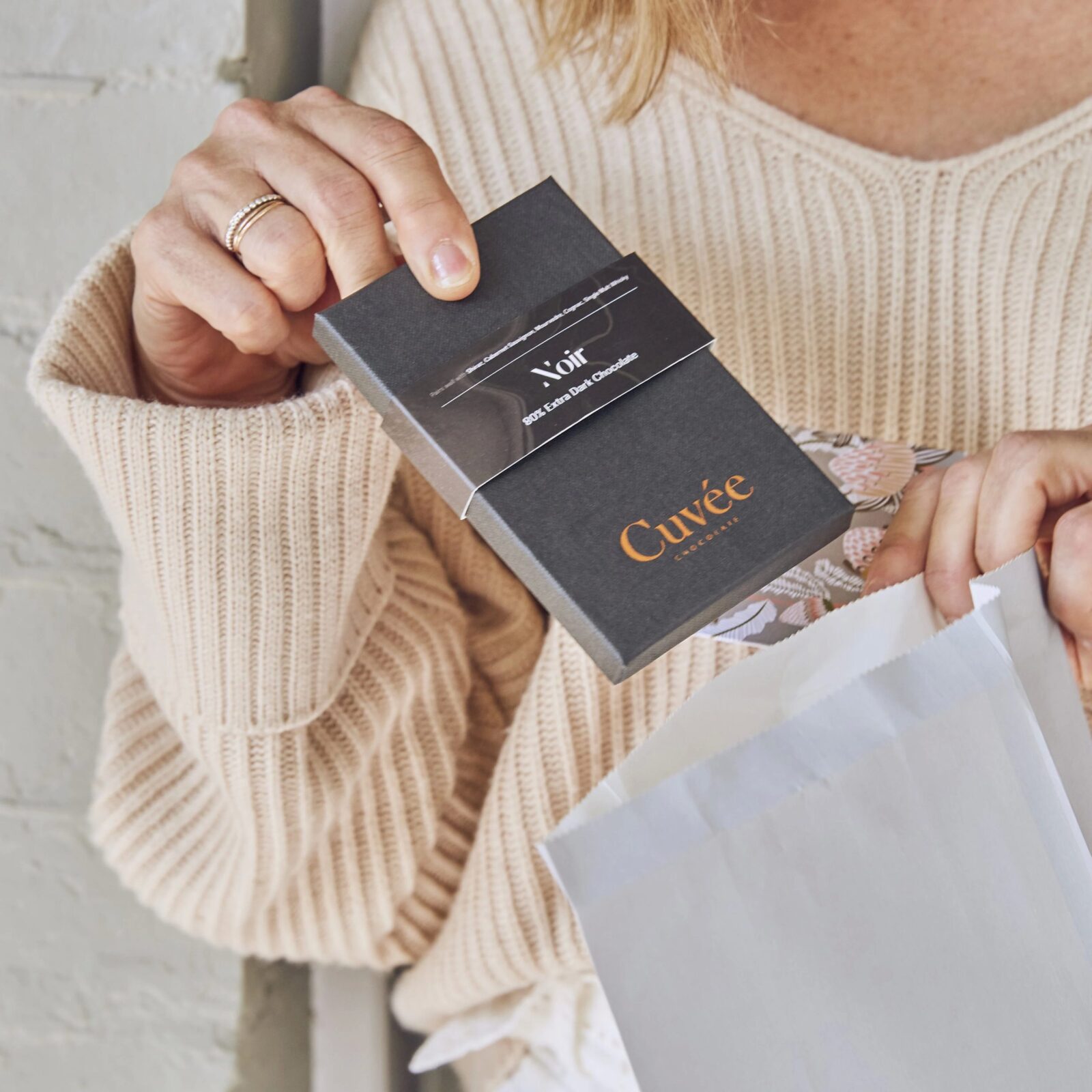 Woman's hand holding Cuvee chocolate